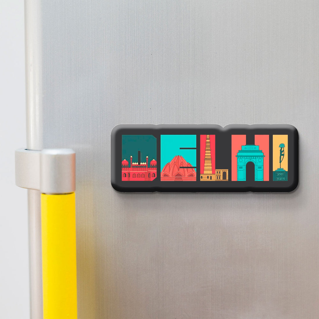 Decorative 'DELHI' fridge magnet with colorful illustrations on a refrigerator