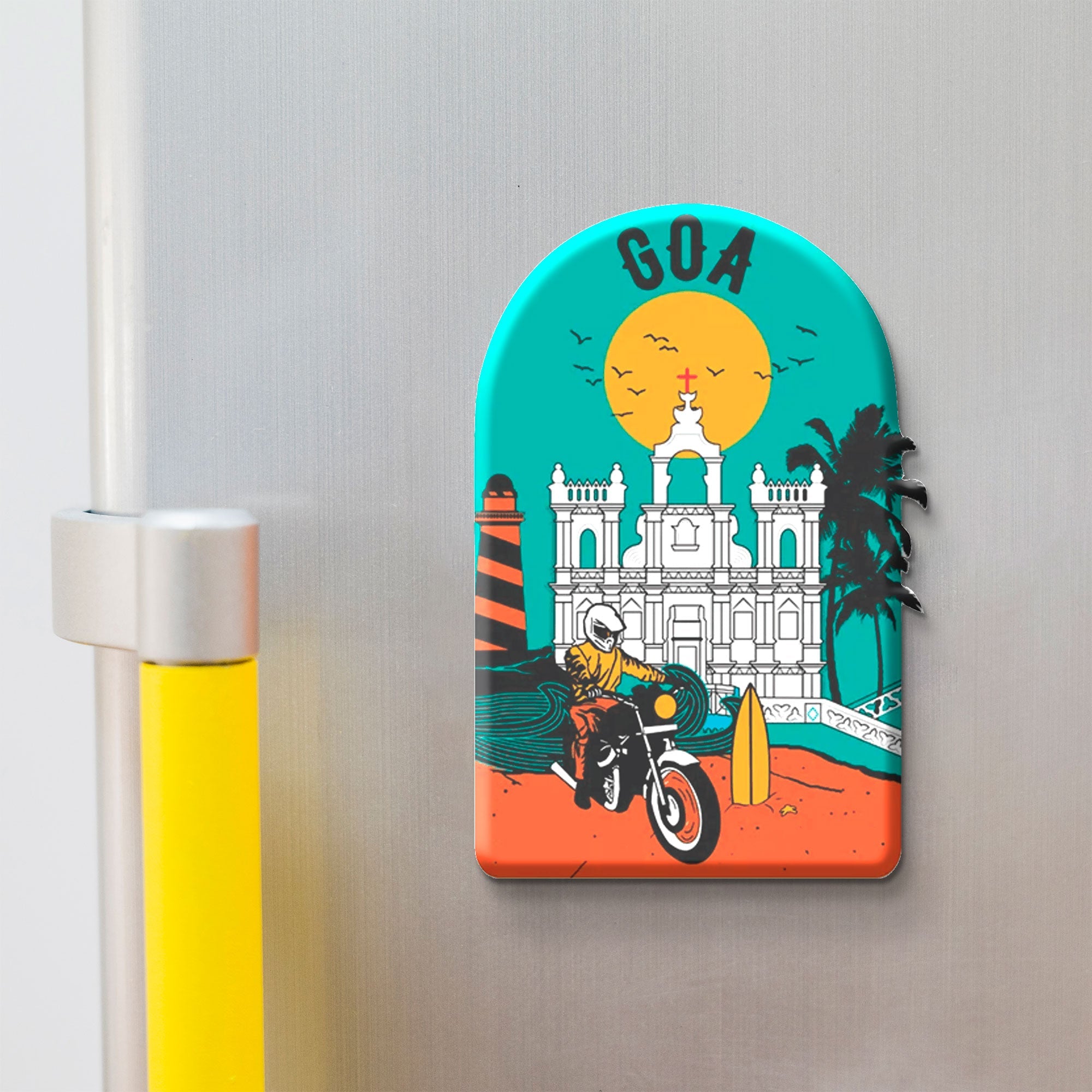 Decorative magnet with a design of a building, palm trees, and a person on a motorcycle on a metallic surface.